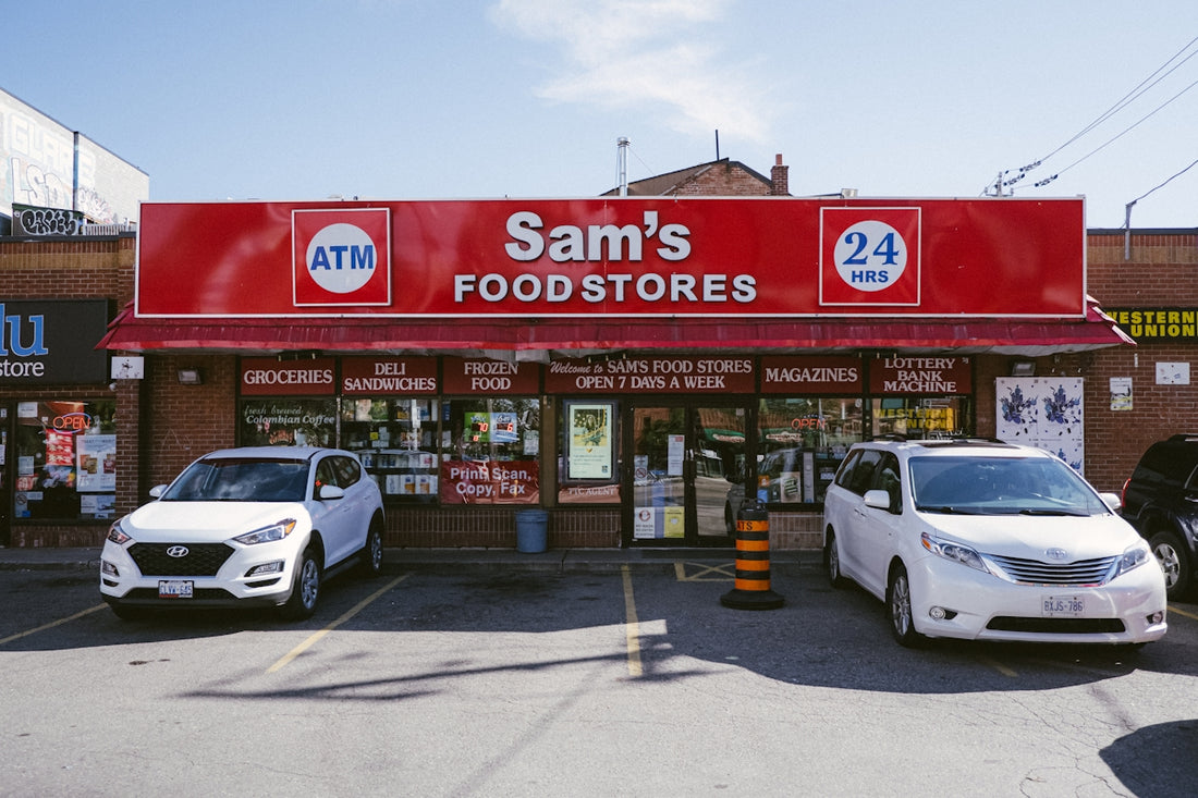 A sam's food store with cars parked in front of it