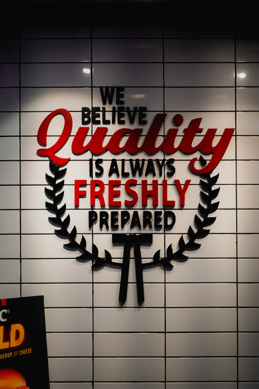 Wall art with text about quality and freshness.