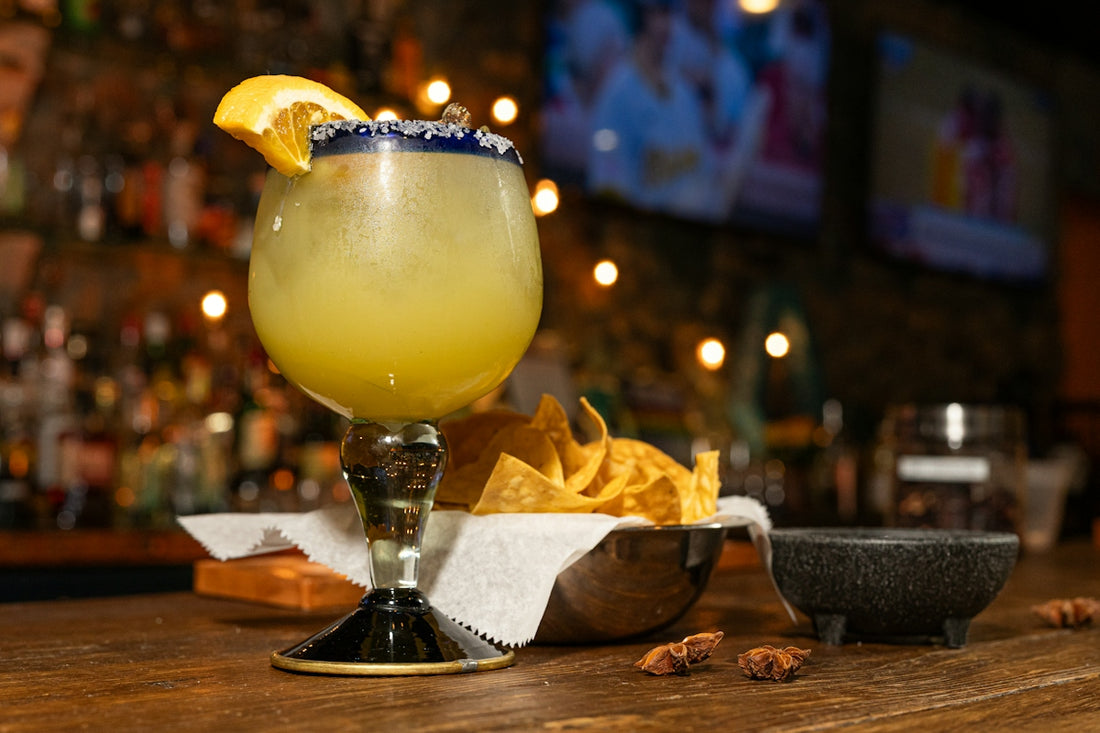 Margarita with a salt rim and lime garnish, served with chips