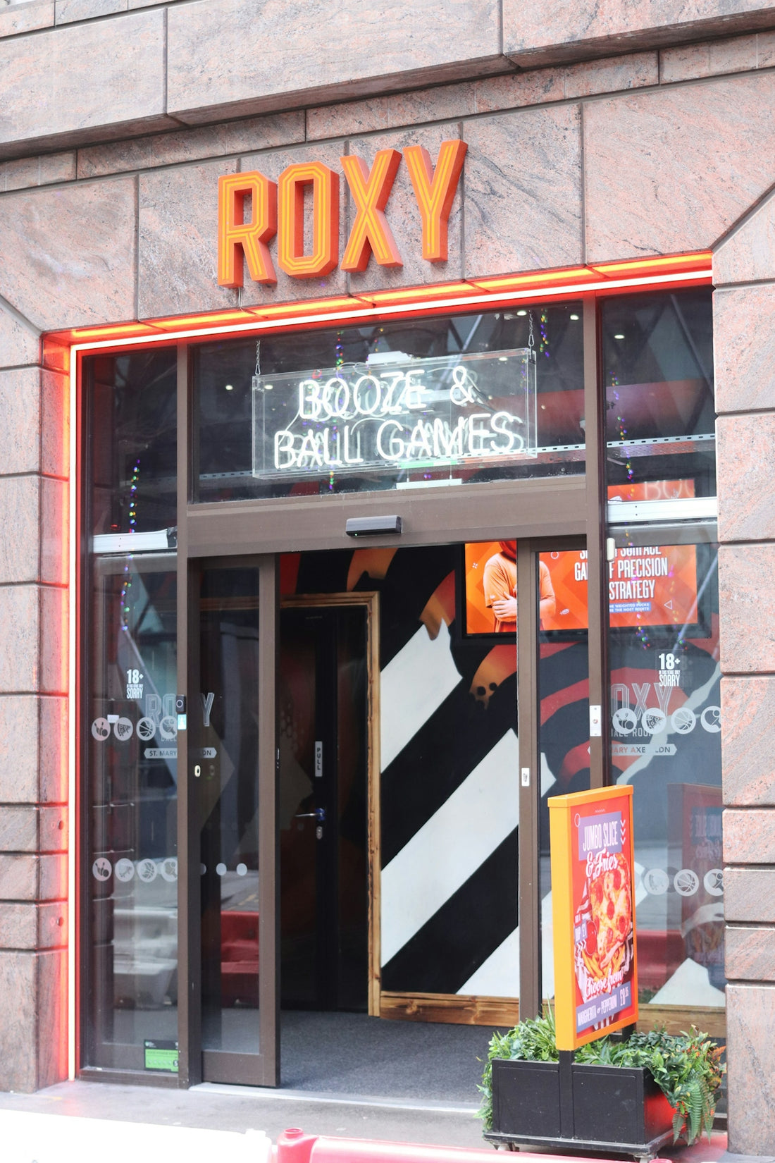 Roxy bar with neon sign for booze and ball games