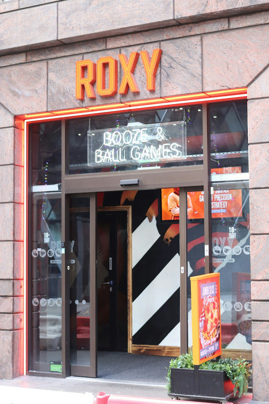 Roxy bar with neon sign for booze and ball games