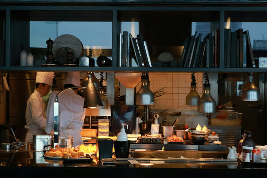 Chefs working in a busy professional kitchen preparing food