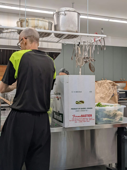 Man preparing food in a commercial kitchen.