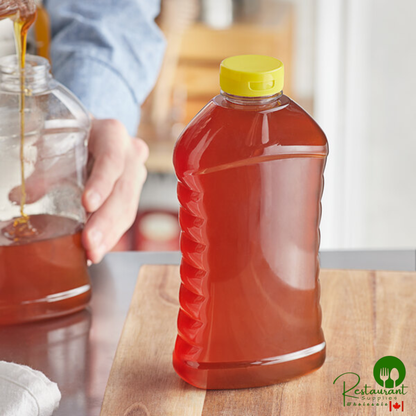 27 oz. (40 oz. Honey Weight) Ribbed Hourglass PET Honey Bottle with Pressure Sensitive Liner Yellow Plastic Flip Top Lid - 135/Case